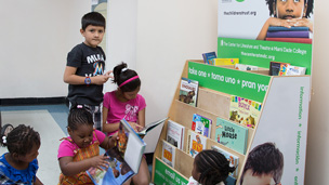 Kids browsing books at a Read to Learn Books for Free book shelf.