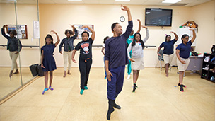 African American male youth leading ballet class^
